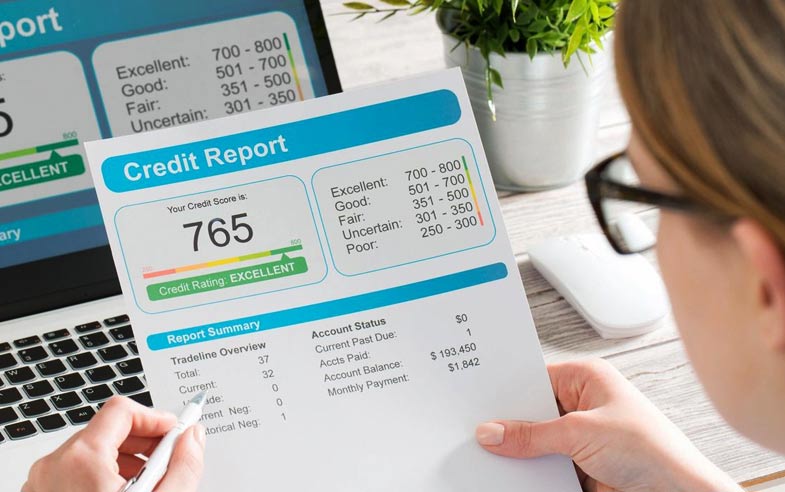 Woman with credit scores document after credit repair in Boston, MA